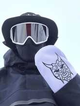 Load image into Gallery viewer, Sweetmitts Oni Mitts are stylish white snowboard mittens with a silicone black oni demon logo. These stylish snowboard mittens are paired with a Sweetmitts black wide-brim hat for a steezy outfit look.
